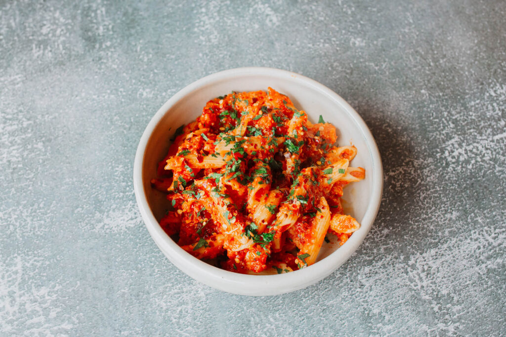Arrabiata : crispy chicken and pasta with a spicy tomato sauce, pecorino and extra virgin olive oil